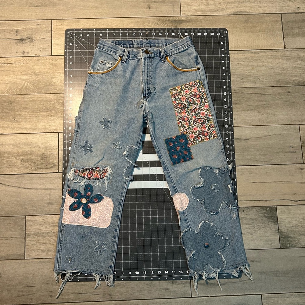 One-of-a-kind jeans. Handmade flower patches and hands sewn embroidered designs.